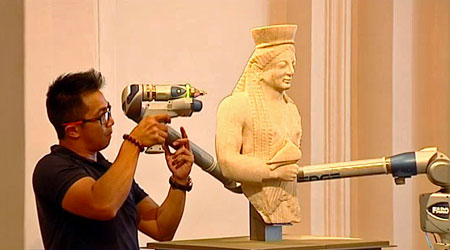 A member of Arskan scanning in 3D a statue with the 3D scanner FaroArm.